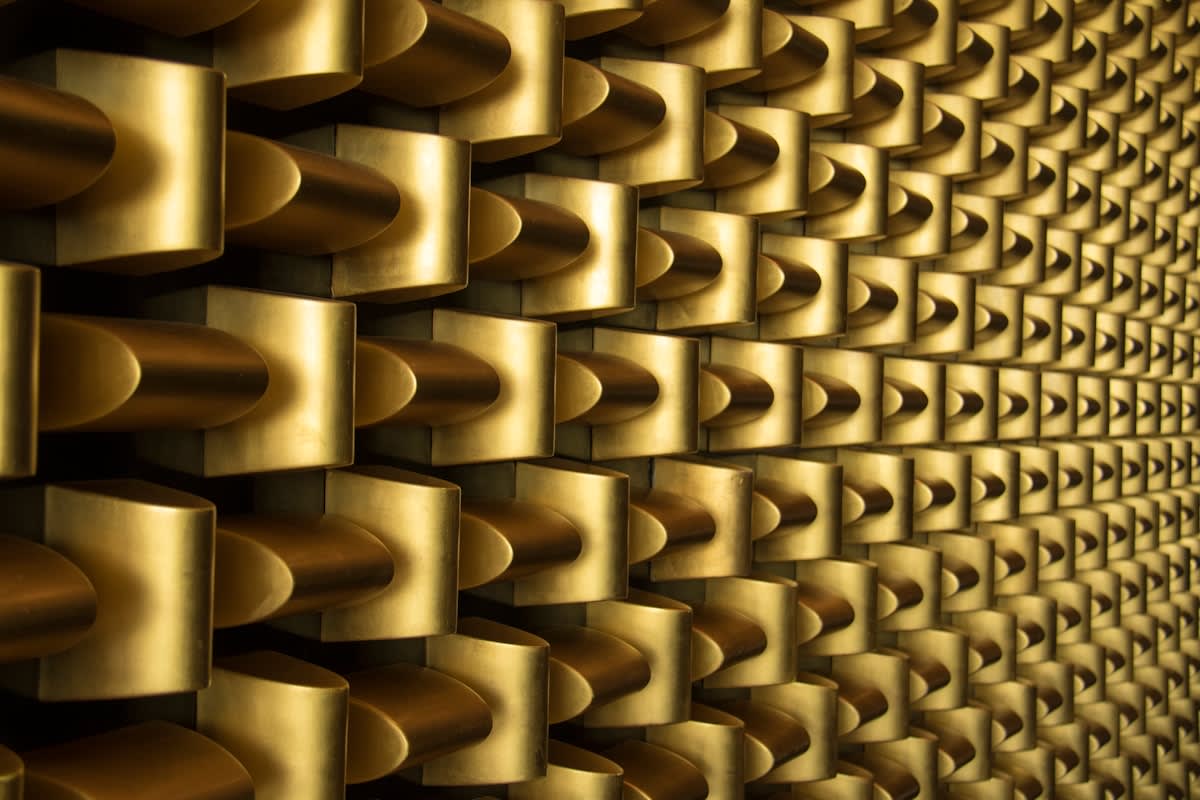Abstract visualization of a global digital network connecting physical buildings and gold bars