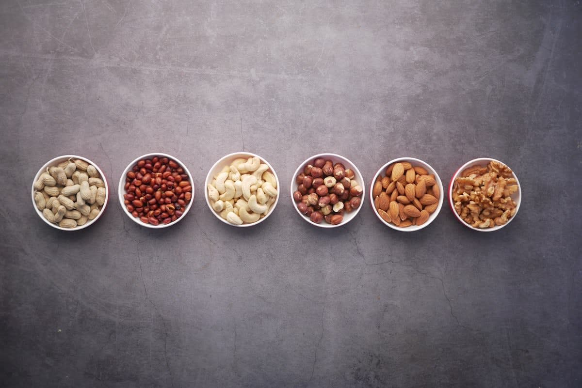 Various high protein foods including eggs, fish, tofu, and nuts