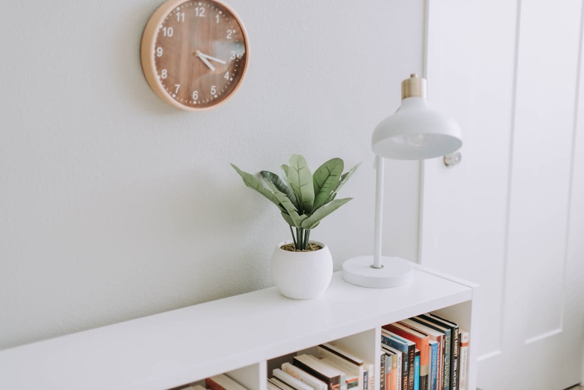 Minimalist workspace with a notebook and a clock