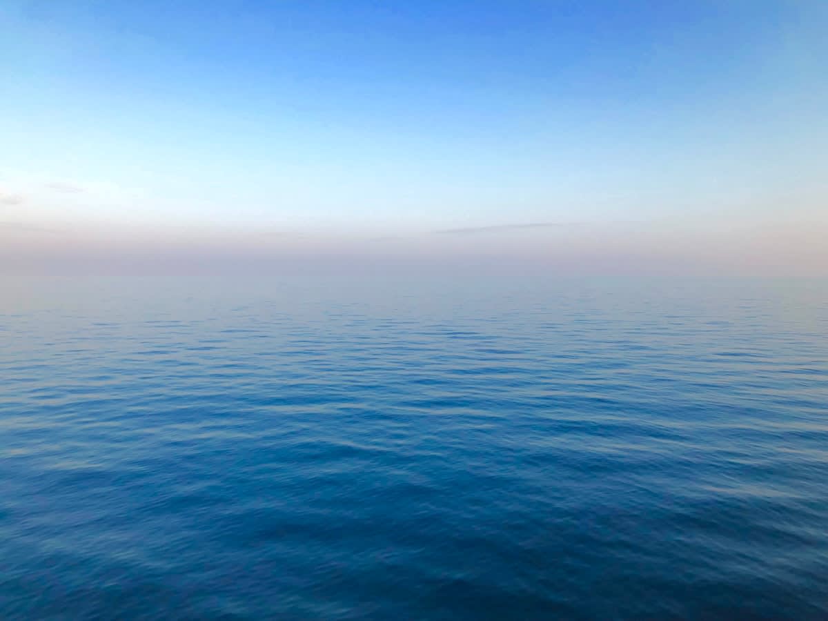 A calm ocean horizon at dawn