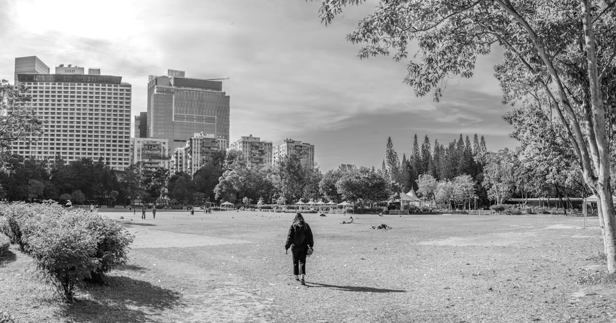 Person walking in a city park during a lunch break