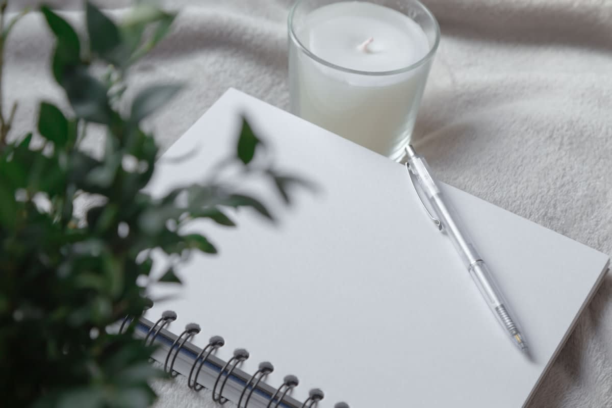 A clean desk with a single notebook and pen
