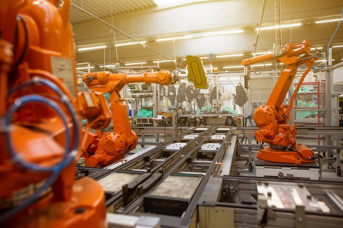 Automated warehouse with robotic arms and conveyors