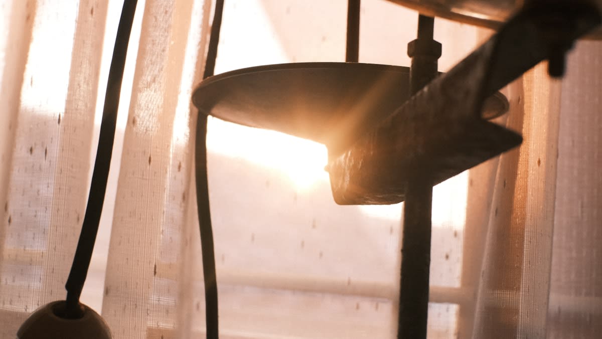 Analog vinyl record player with dust particles in a sunbeam