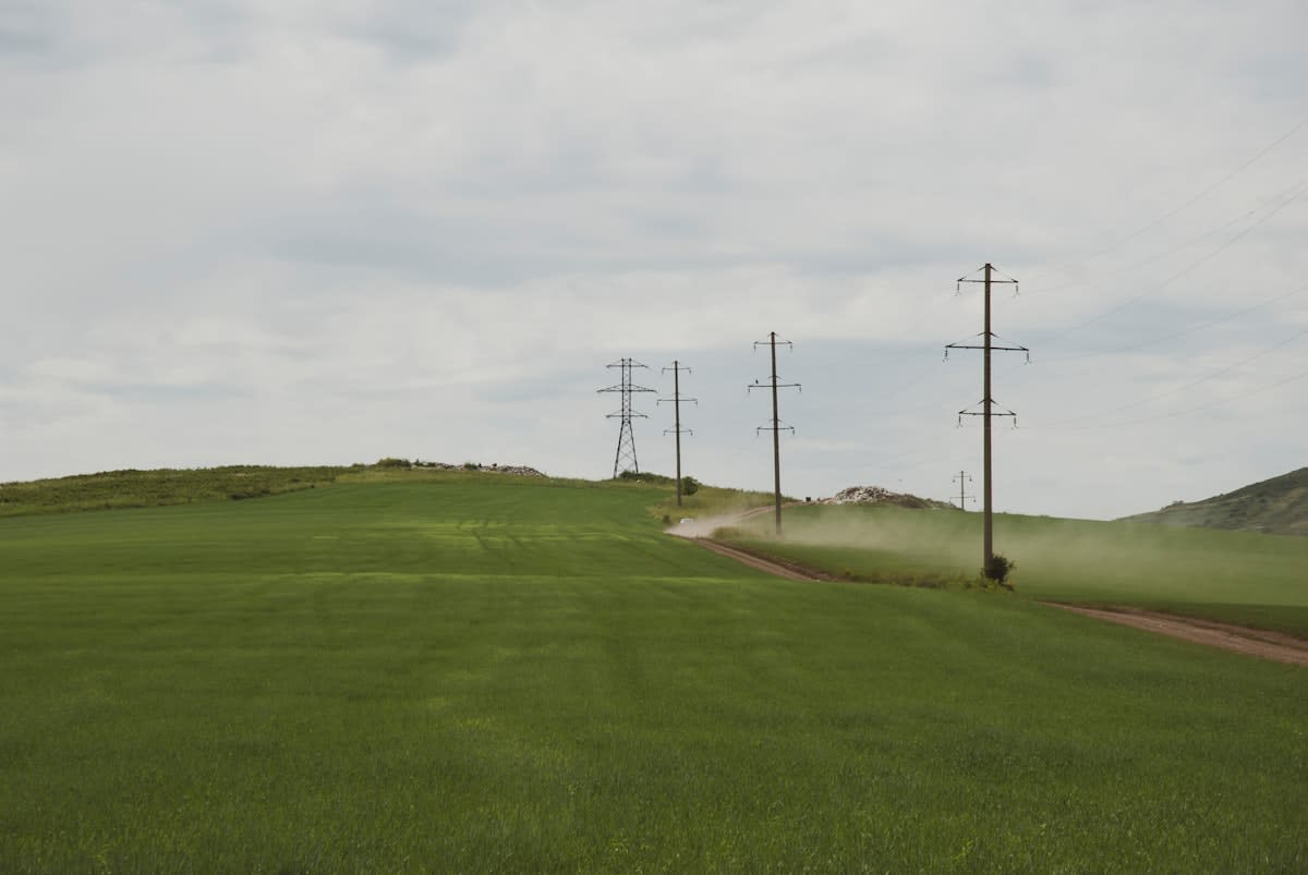 High voltage power lines crossing a vast landscape