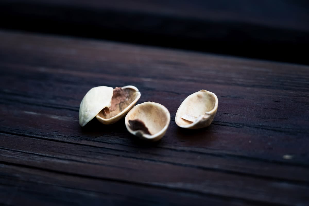 A handful of almonds on a wooden table
