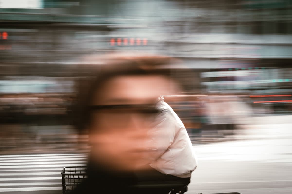 person focusing on one clear path among many blurred options