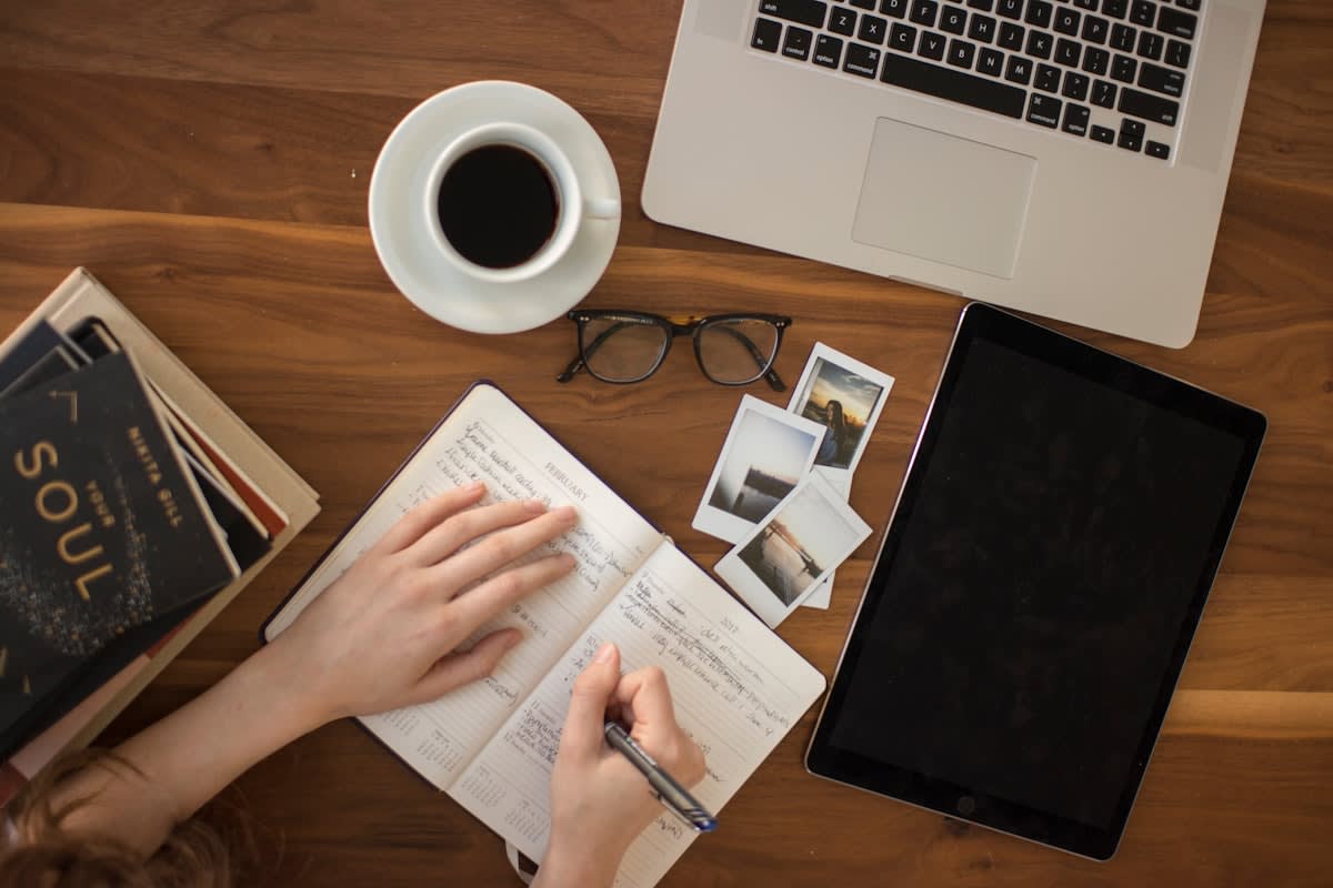 Person writing in a journal and tracking data