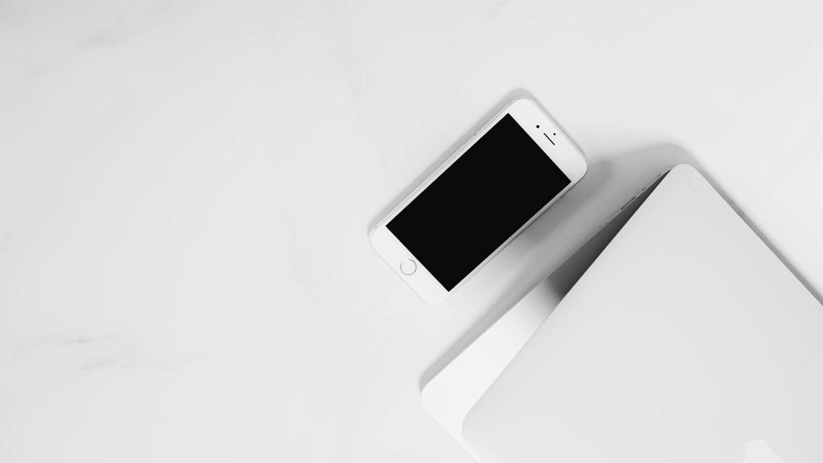 A retro flip phone sitting next to a modern smartphone on a marble table