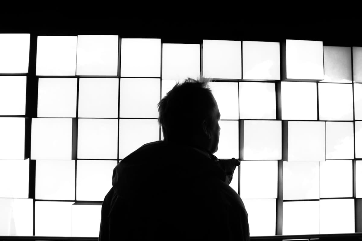 person looking overwhelmed by many digital screens