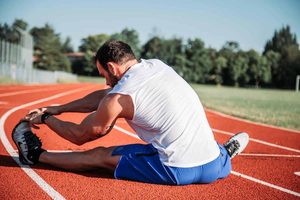 Close up of athlete stretching calves and ankles