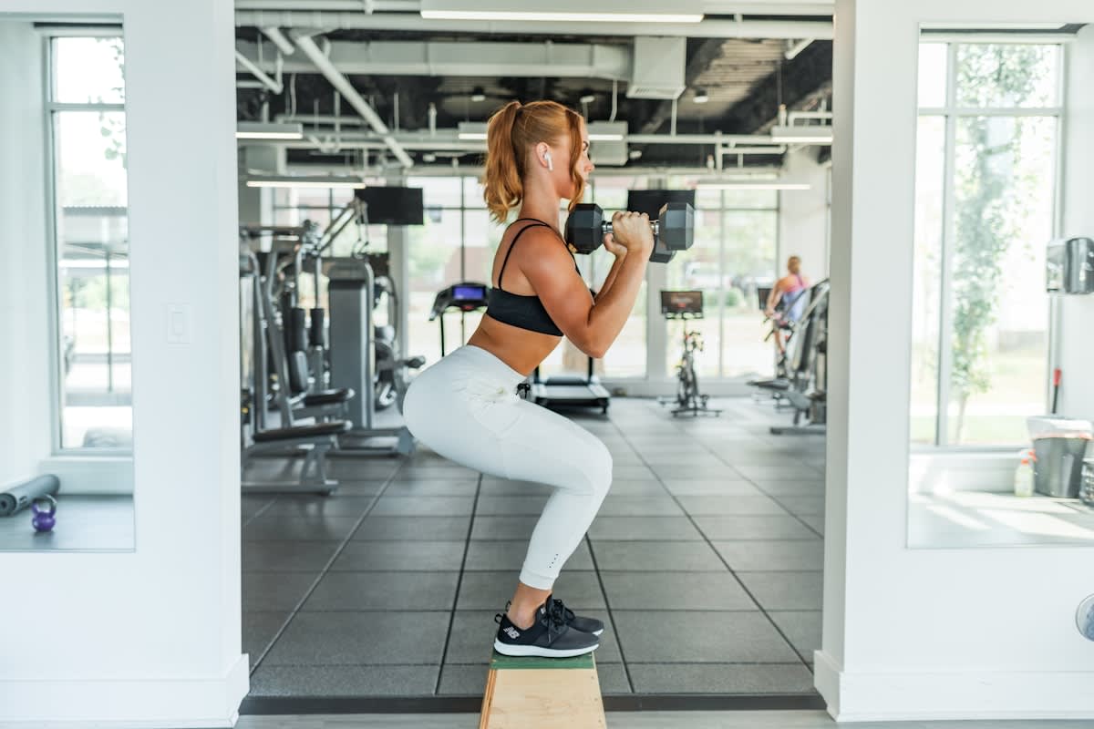 Person lifting weights in a modern gym