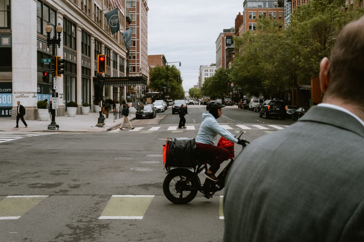 Busy city street with delivery bikes and pedestrians