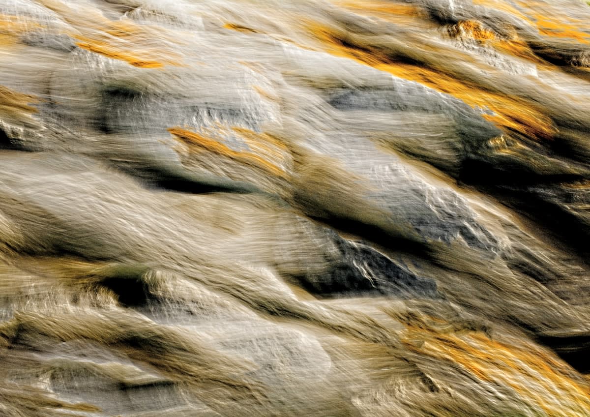abstract representation of a streamlined flow or a river cutting through rock