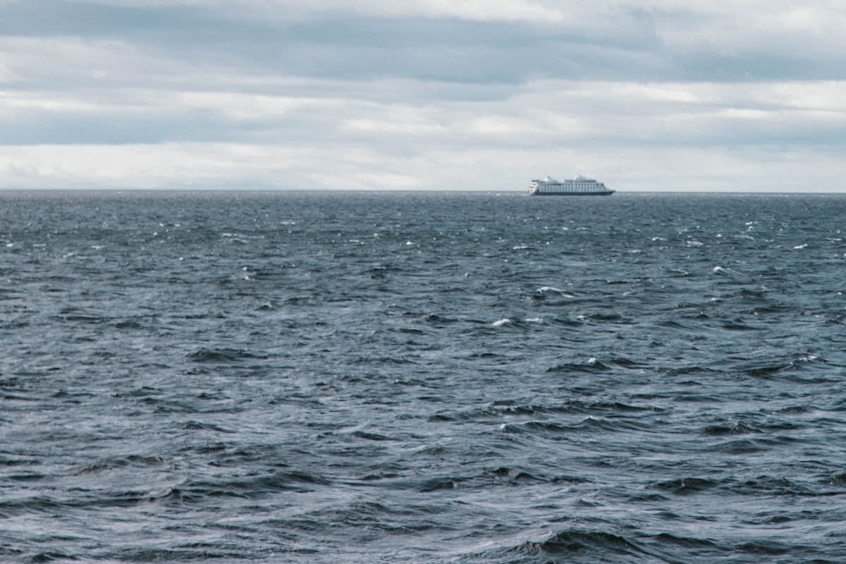 Cargo ship navigating a narrow maritime strait