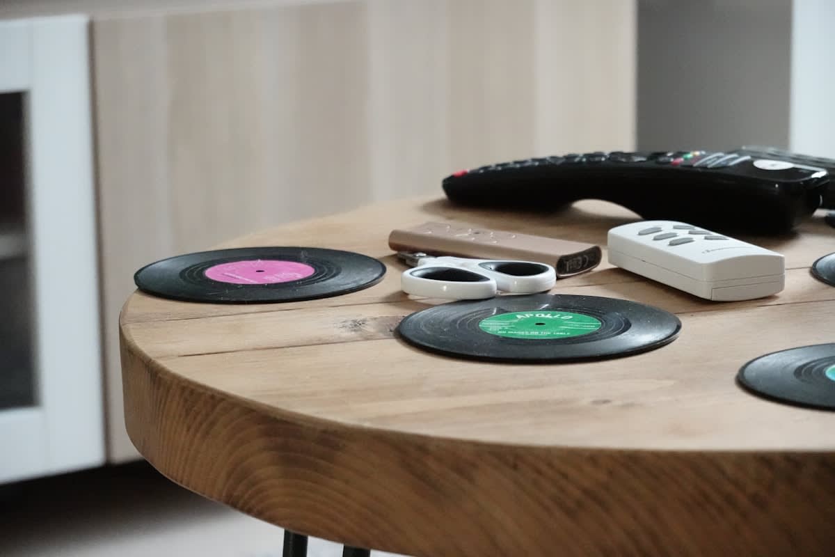 Vinyl records and film cameras on a wooden table