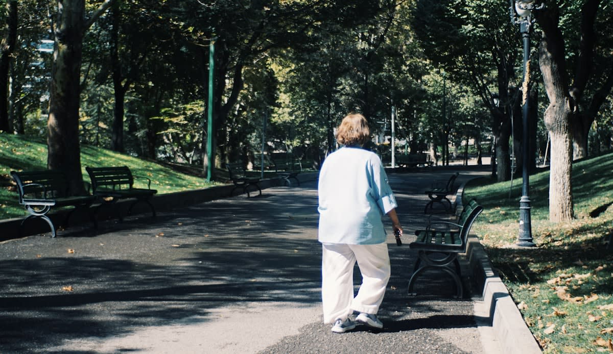 older adult walking in a park