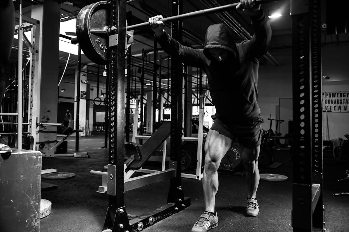 person performing squats in a gym