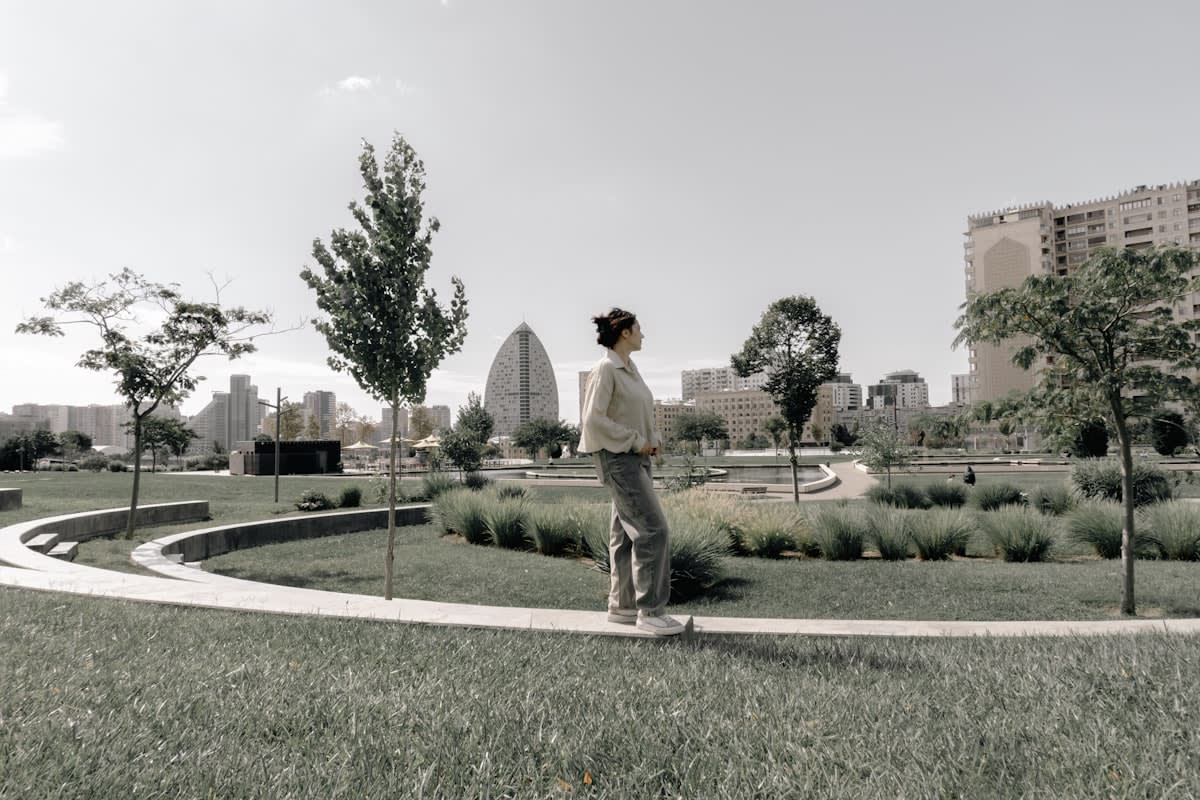 A person walking alone in a minimalist urban park