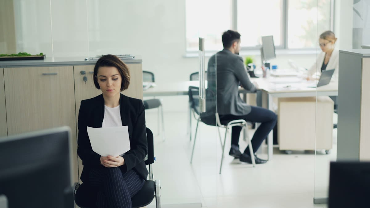 Person meditating in a professional office setting