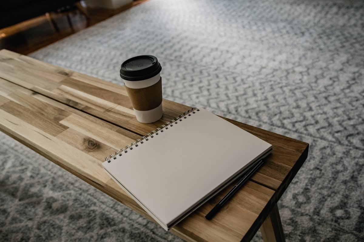 Minimalist desk with a notebook and a single pen