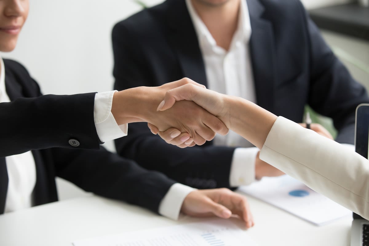 A close-up of a handshake or a trust-based interaction