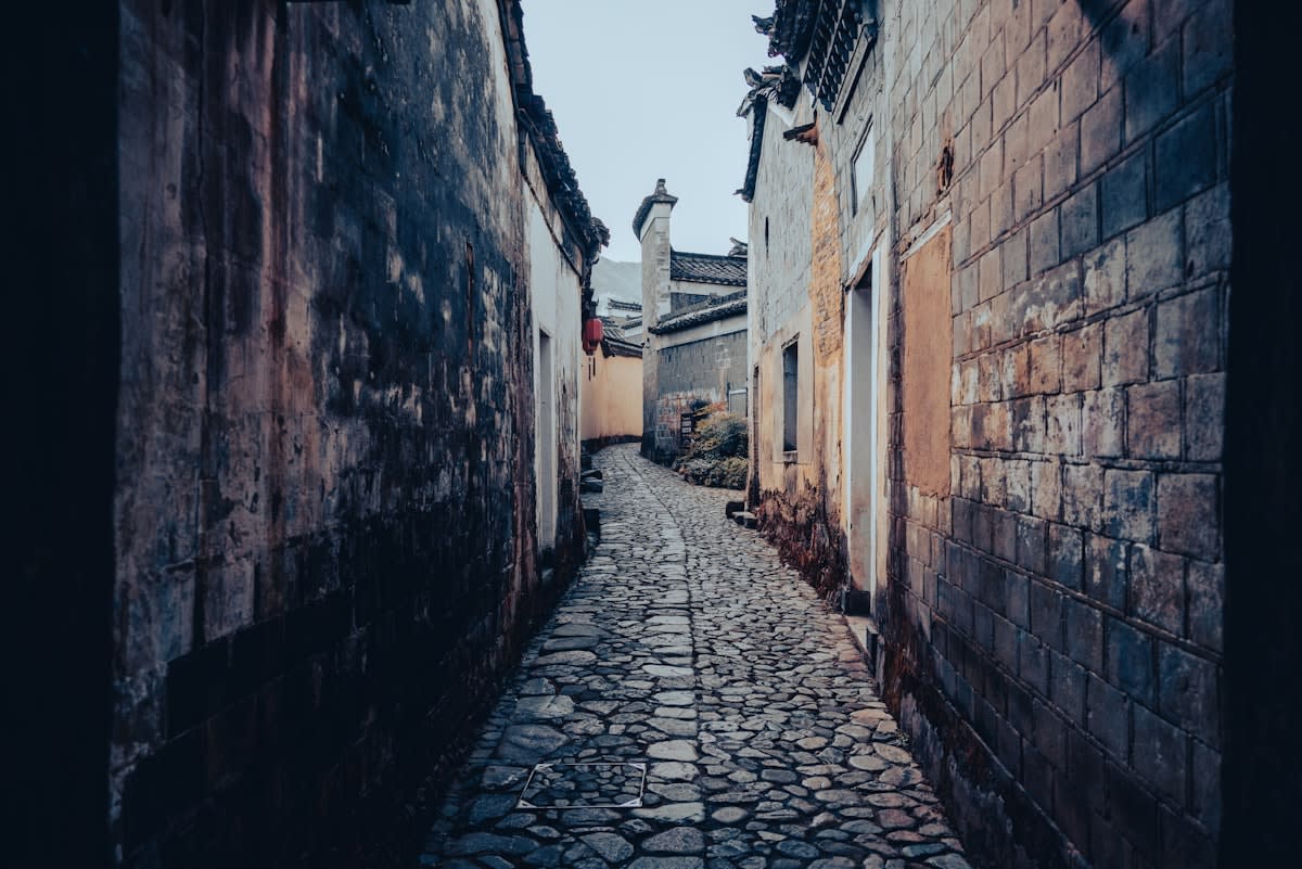 quiet cobblestone street in a small European or Asian village