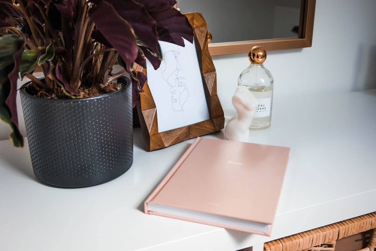 A minimalist workspace with a physical book and a journal