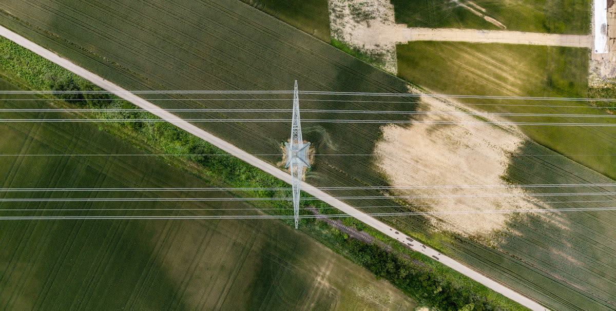 Aerial view of high voltage power lines across a landscape