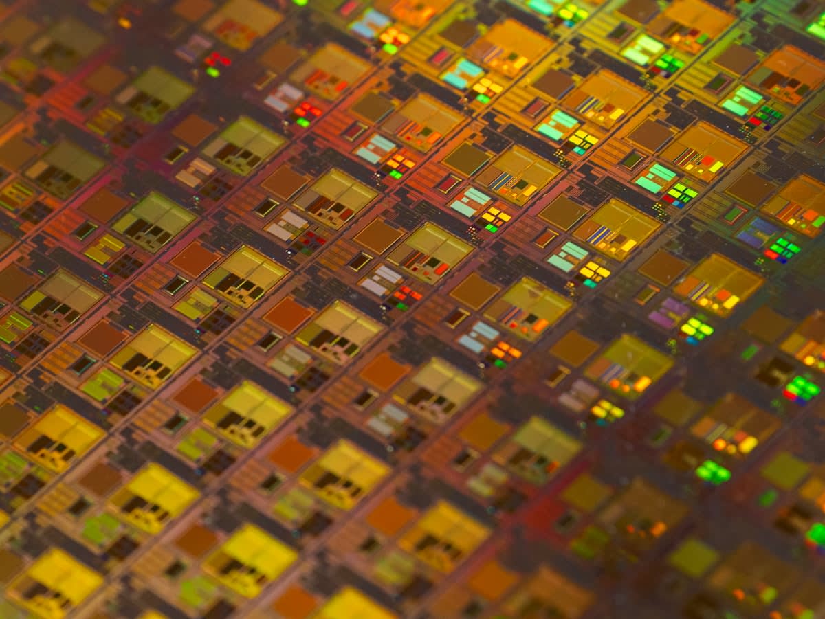 Macro shot of a semiconductor wafer with glowing circuits