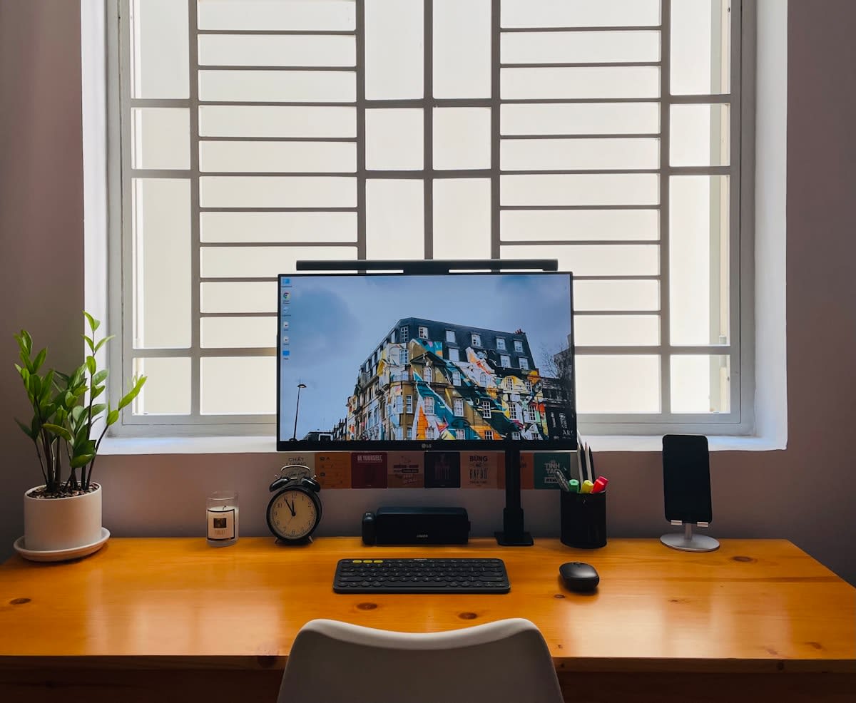 Minimalist workspace with a single notebook and a window