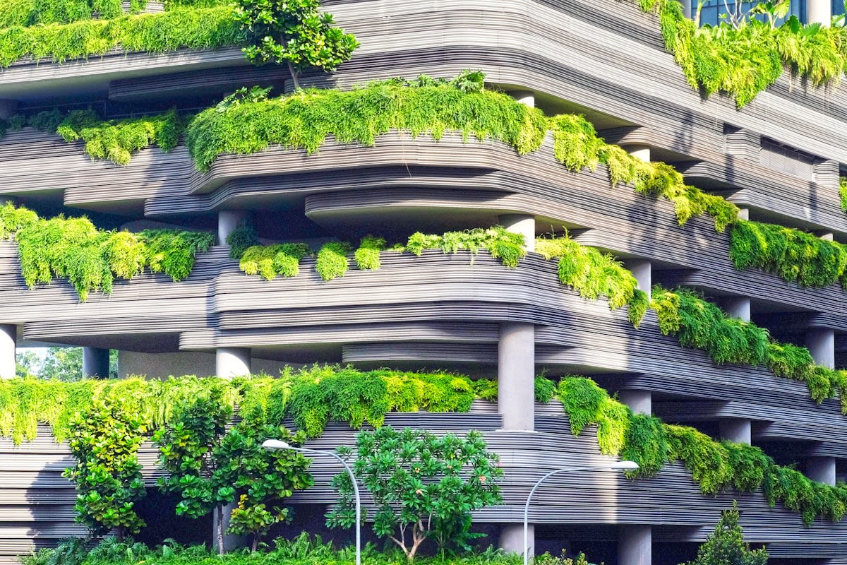 Modern sustainable architecture with integrated greenery and reflective surfaces