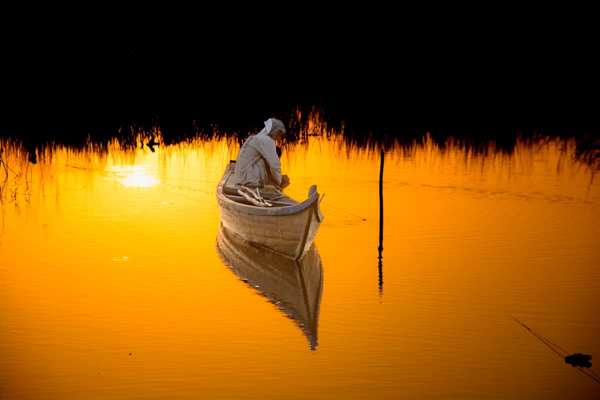 Person meditating in a quiet natural setting