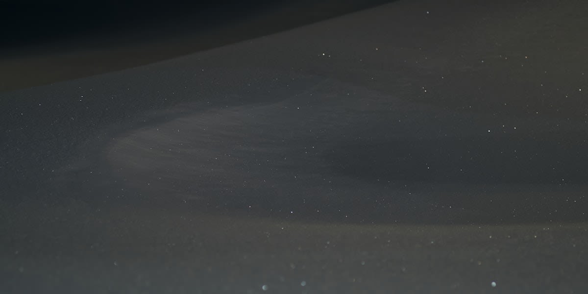 Long exposure of stars over a desolate landscape