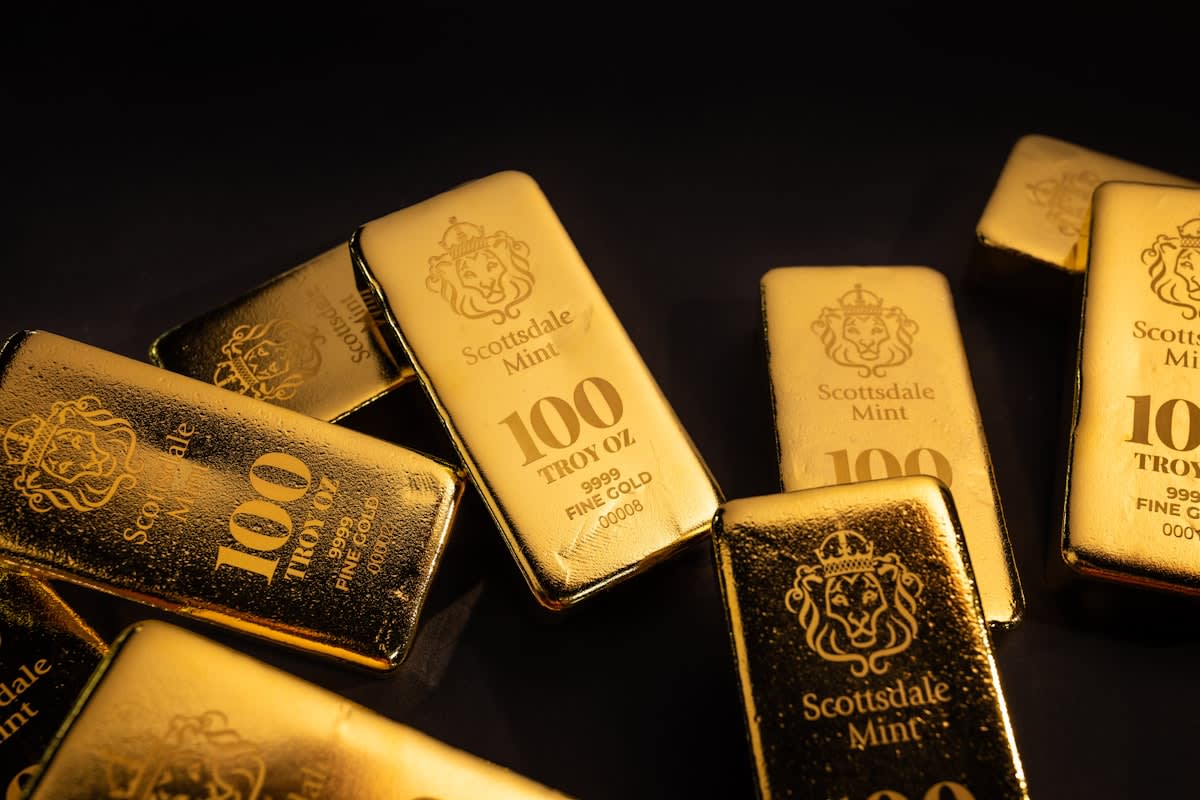 Gold bars and digital data overlays