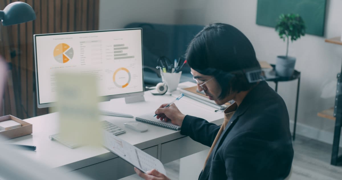 A high-tech workspace with data visualizations and a person studying intensely