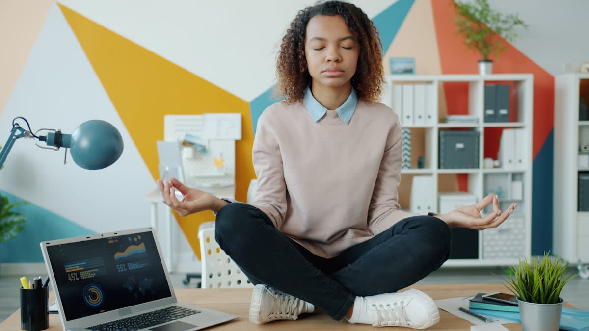 Person meditating in a modern office