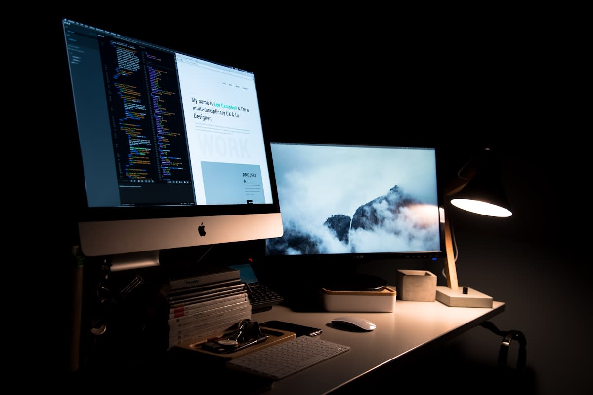Minimalist workspace with a computer showing a bold website