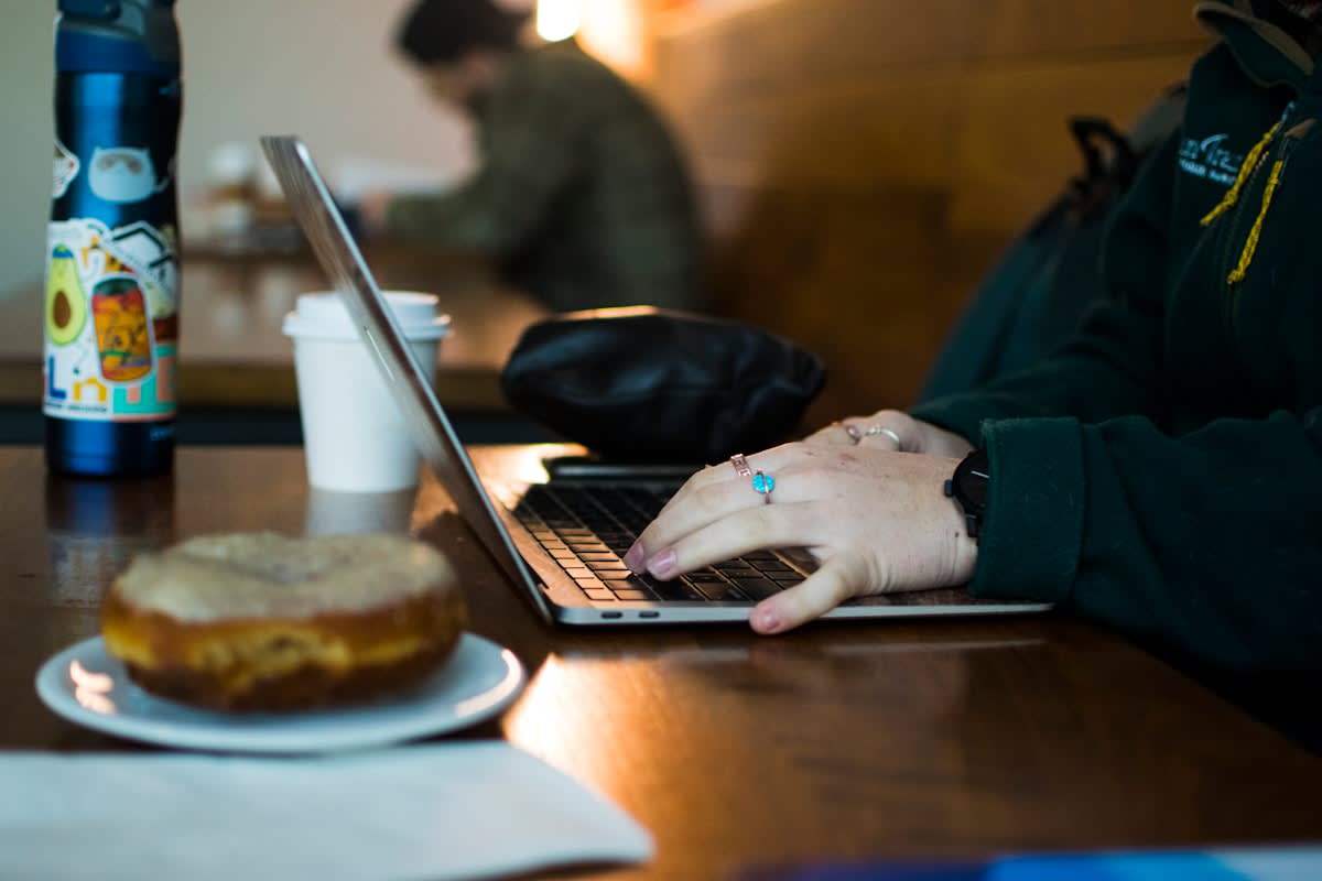 Crowded digital nomad cafe with laptops