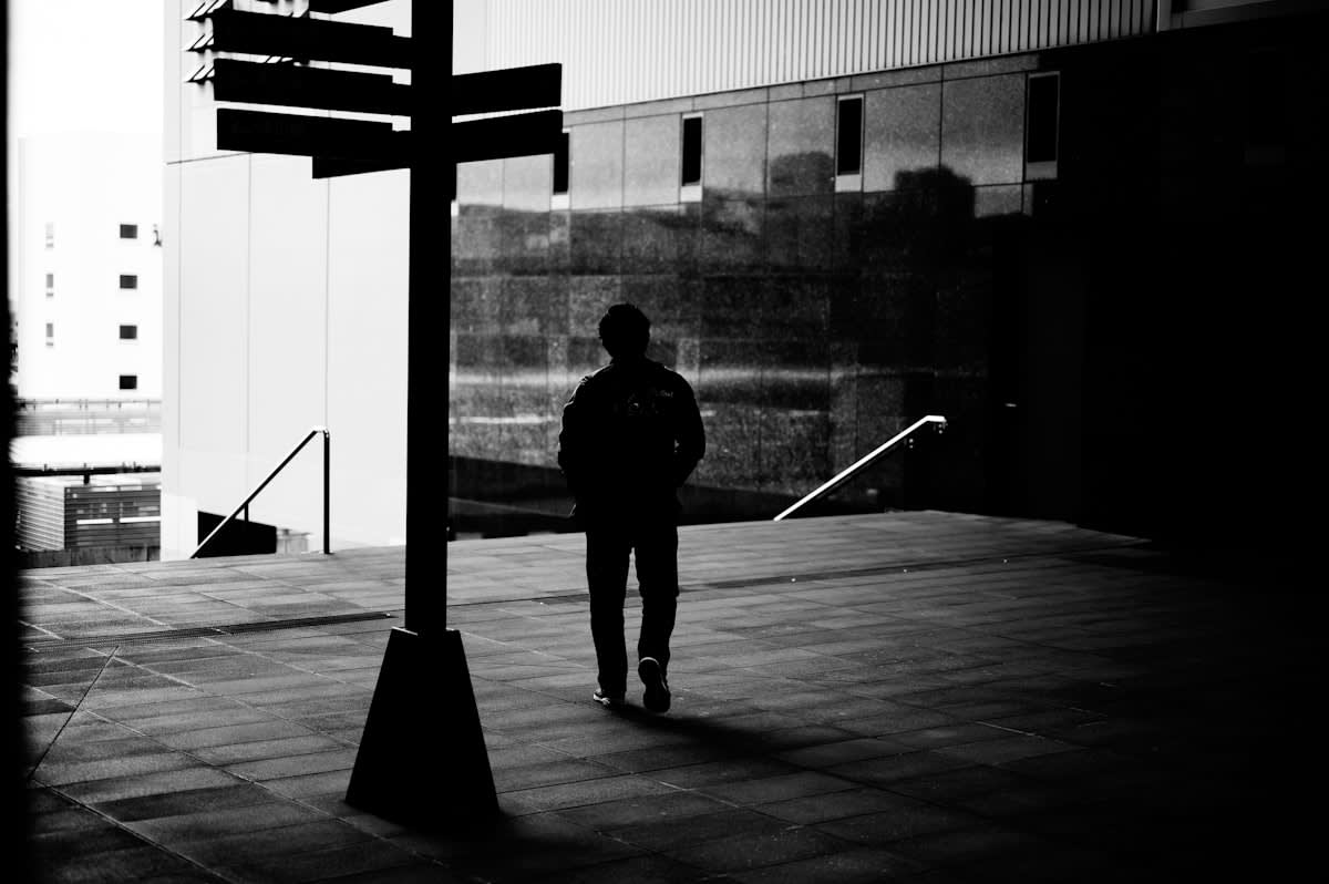 Person looking at a crossroads in a modern city