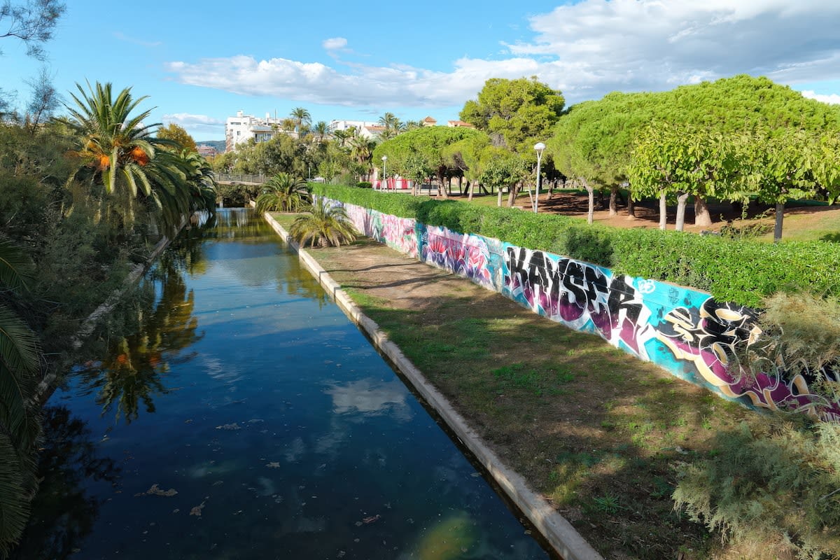 Modern urban park with acoustic buffering vegetation and water features