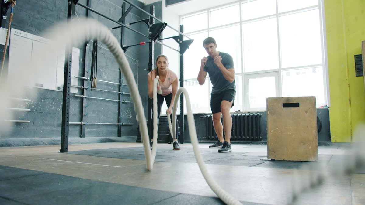 Athlete performing a jump test on force plates in a high performance gym