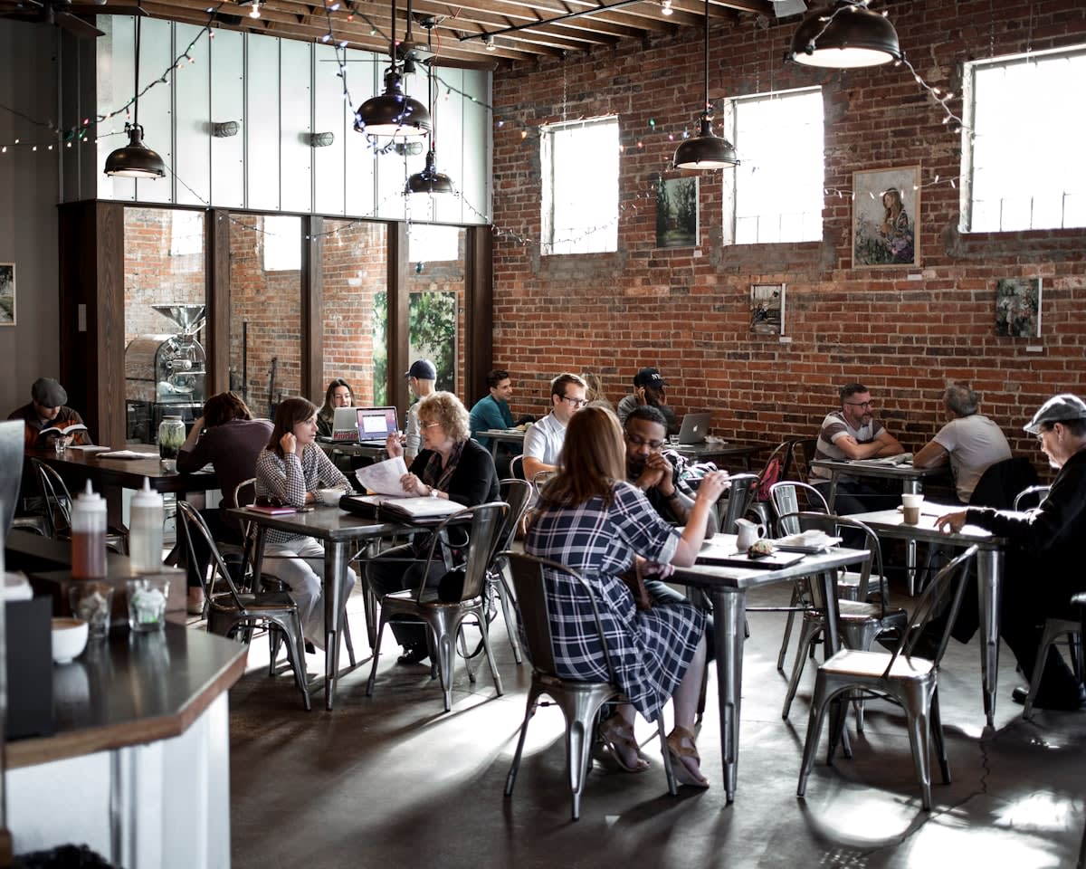 A cozy independent cafe with people chatting