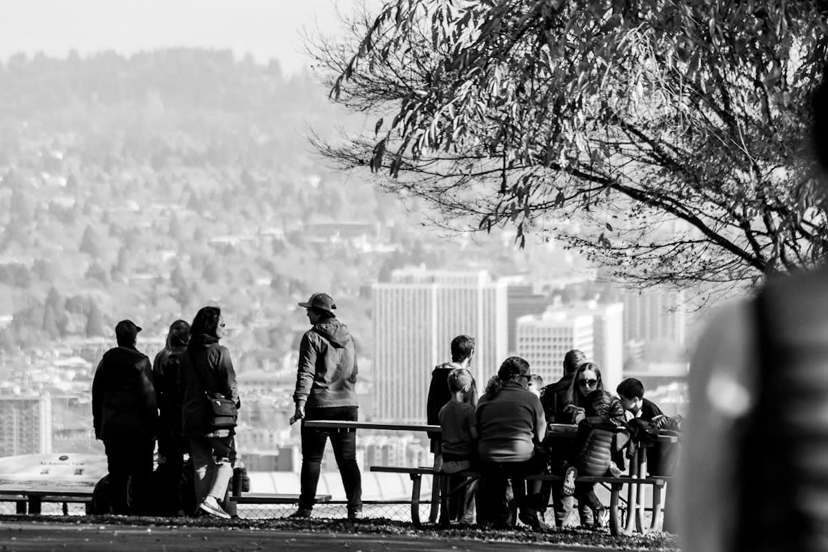 A group of diverse people talking in a city park