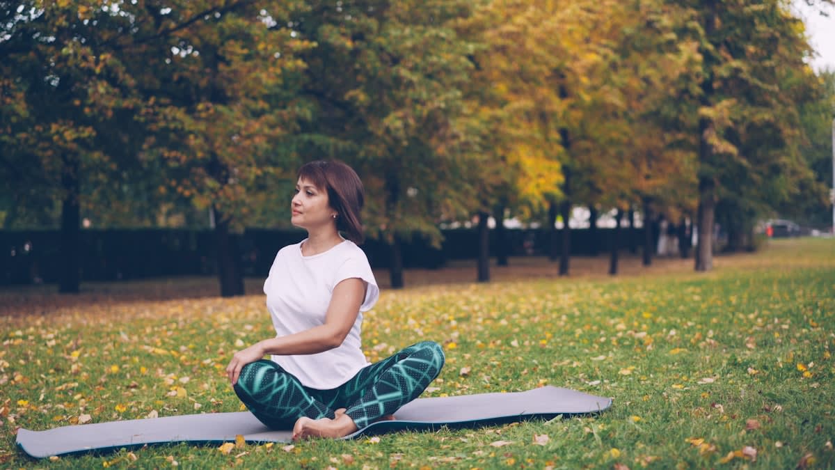 Person meditating in a natural park setting