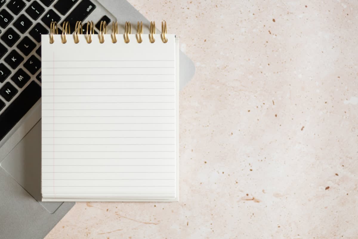 A minimalist workspace with a single notebook and pen