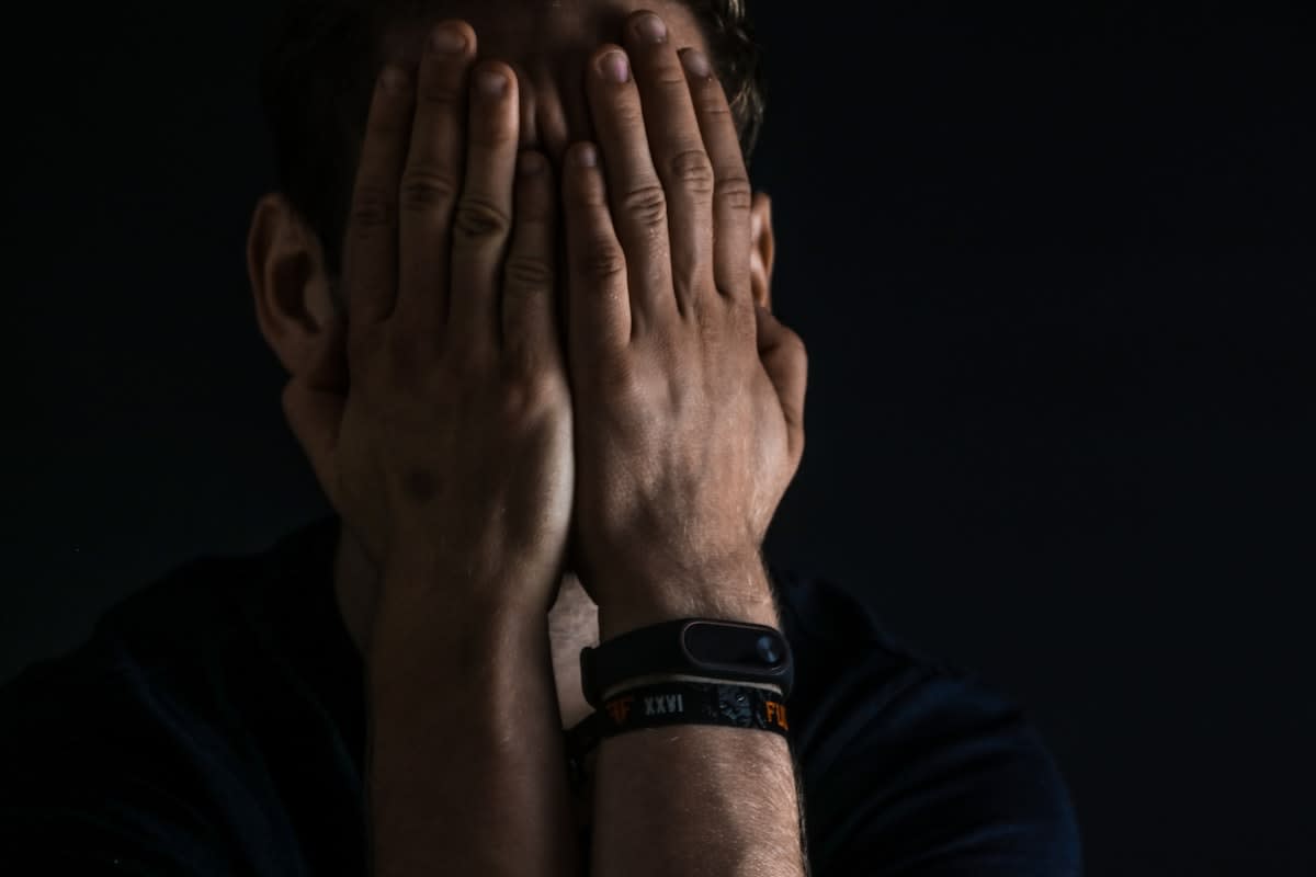 A person looking stressed while checking a fitness tracker