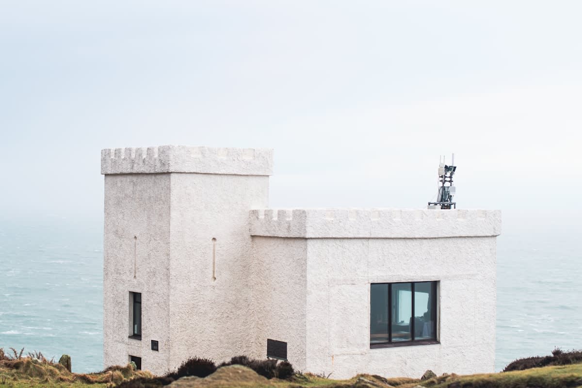 Minimalist concrete architecture integrated into a cliffside