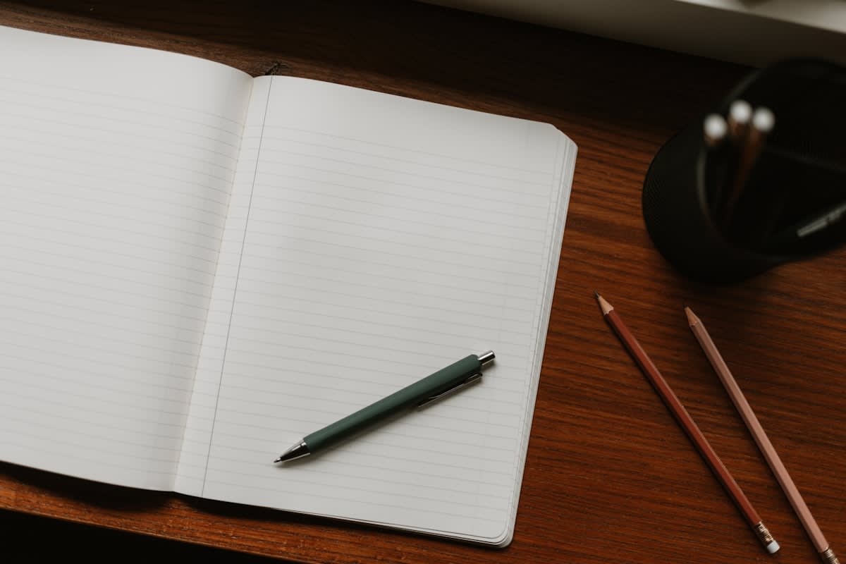 analog notebook and pen on a wooden desk