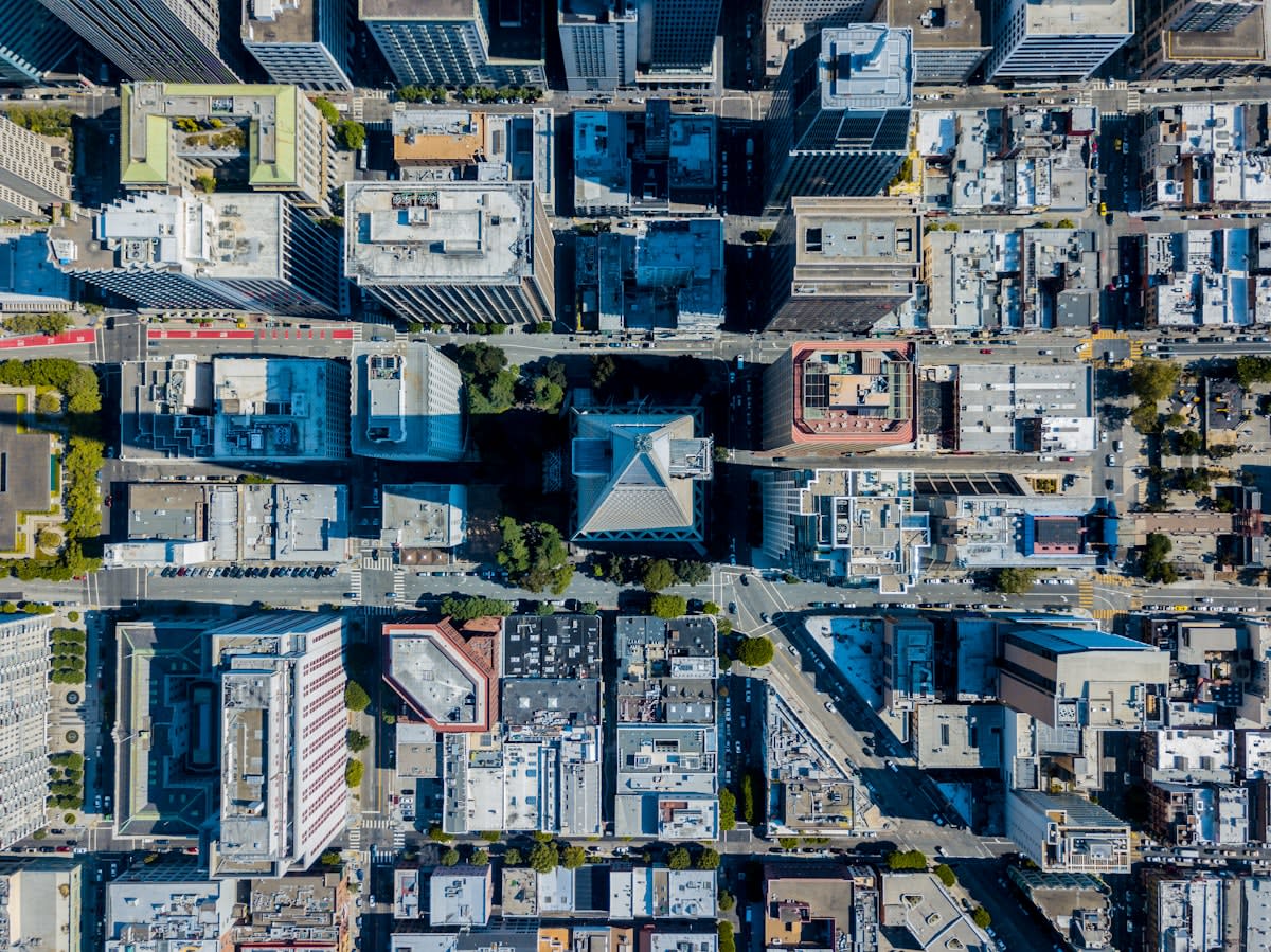Aerial view of a dense city with white roofs